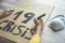 Young woman preparing a banner for Covid 19 economic crisis protest - Coronavirus world pandemic disaster concept - Focus on