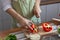 Young woman preparing bell pepper as a breakfast ingredient and ready for healthy cooking and on the table there are vegetables