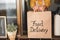 Young woman preparing food delivery inside ghost kitchen during quarantine isolation time - Take away meal for online order -