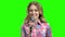 Young woman presenter holding microphone on green screen.