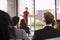 Young woman presenting business seminar gestures to audience