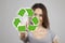 Young woman pressing recycle icons