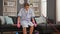 Young woman professional cleaner tired sitting on table resting at home