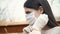 Young woman in protective gloves puts medical mask outside; protection against coronavirus COVID-19