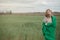 Young woman in protective mask in field. Lady quarantine in the village. Girl and quarantine . Covid-19. Europe