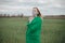 Young woman in protective mask in field. Lady quarantine in the village. Girl and quarantine . Covid-19. Europe