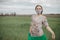 Young woman in protective mask in field. Lady quarantine in the village. Girl and quarantine . Covid-19. Europe