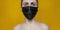 Young woman in protective mask on yellow background banner. Concept Pandemic Epidemic COVID nCoV