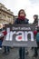 Young woman Protesting with Dont Attack Iran placard sign at a public demonstration