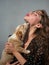 Young woman with puppy dog, sharing a hug, cuddling, kissing, licking. Animal best friend, lovely friendship.