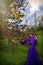 Young woman in purple gown throwing a chicken in the air.