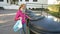 A young woman puting different types of garbage in different recycling bins