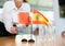 Young woman putting Bahrain and Spain flags on table in office