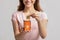 Young Woman Putting Card With Plastic Trash Into Wooden Toy Garbage Bin