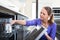 Young woman putting dishes in the dishwasher