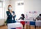 Young woman putting her vote in the ballot box, usa elections and coronavirus.