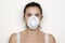 Young woman putting on a mask against swine flu