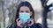 Young woman putting on mask for coronavirus protection