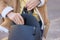 Young woman putting pepper spray into bag outdoors, closeup