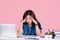 Young woman puzzled tired frustrated in casual shirt and sit work at white office desk use pc laptop computer isolated on pastel