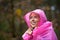 Young woman in raincoat enjoying rainy autumn season