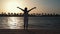 Young woman raising hands at coastline. Pretty girl dreaming fly at beach.