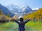 Young woman raising her arms up in the air at Pearl Lake