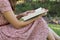 Young woman reading bible in natural park