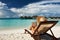 Young woman reading a book at beach