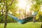 Young woman reading book in comfortable hammock at garden