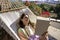 Young woman reading a book in hammock