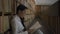 Young woman is reading book sitting on floor in university library.