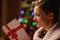 Young woman reading Christmas postcard