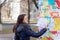 Young woman reading a notice on a noticeboard