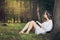 Young woman reading pecefully in beautiful forest