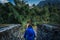 Young woman ready to cross suspension bridge in Annapurna Base Camp trekking in Nepal