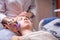 Young woman receiving facial treatment.