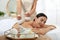 Young woman receiving herbal bag massage in spa