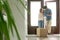 Young woman receiving parcel cardboard box from courier at home