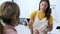 Young woman recording a video of her young professional nutritionist while preparing healthy dishes in the kitchen at home.