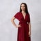 Young woman in red bandeau maxi dress