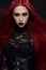 Young woman with red hair in black gothic costume