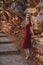 Young Woman In Red Linen Dress Near Orange Rocks Sveti Stefan Muntenegru