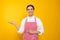 Young woman in red striped apron on yellow background