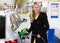 Young woman refilling car in gas station