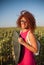 Young woman with reflector in hands, photographer assistant works in meadow