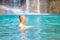 Young woman relaxes in emerald blue lake, Erawan National park, Thailand