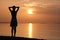 Young woman relaxing alone on ocean sand shore by seaside enjoying warm tropical evening