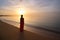 Young woman relaxing alone on ocean sand shore by seaside enjoying warm tropical evening