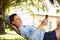 Young woman relaxing on a hammock with a mobile phone